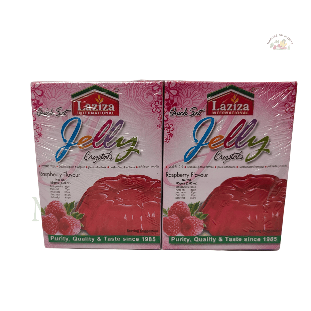 Paquet de Jelly Raspberry Flavour 85g, avec des framboises fraîches en arrière-plan.